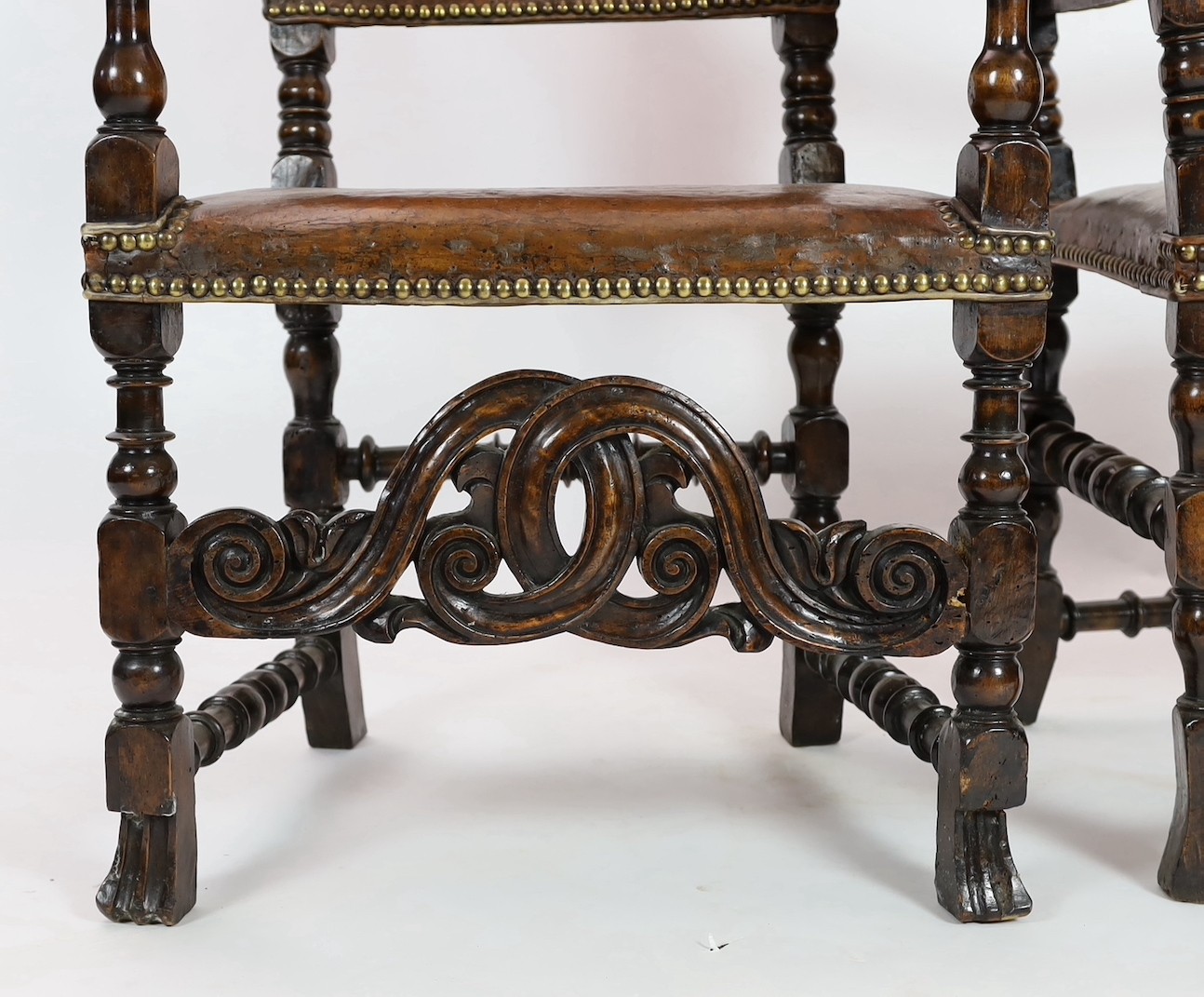 A pair of late 17th century Spanish walnut and elm armchairs, width 69cm, depth 61cm, height 141cm